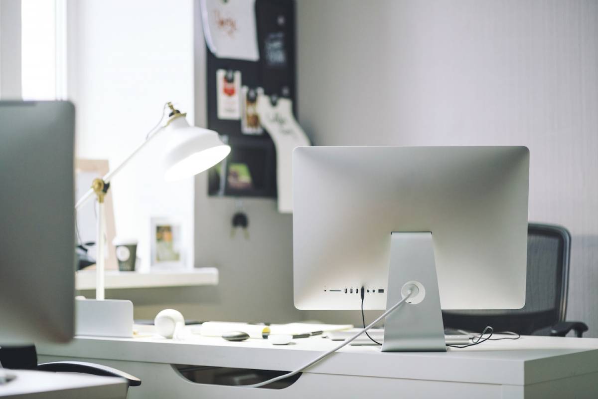 A computer monitor placed on a wooden desk, showcasing a clean and organized workspace.