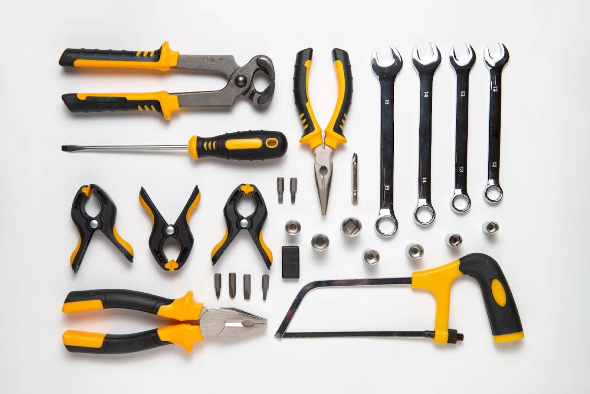 A collection of various tools arranged neatly on a white surface, showcasing their different shapes and sizes. 
